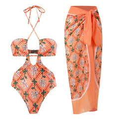 Orange floral printed one-piece swimsuit and matching sarong skirt.