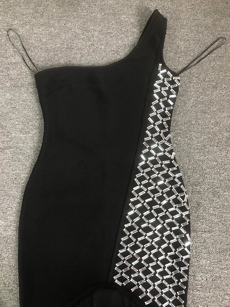 Black dress with geometric pattern on a gray surface