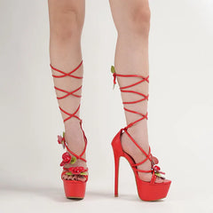 Red high-heeled shoes with floral details 