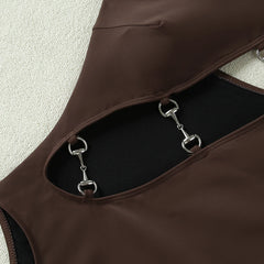 Close-up of metal hardware detail on a one-piece swimsuit cut-out
