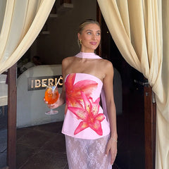 Woman in a floral dress holding a drink in front of an 'Iberico' sign.