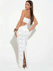 Woman wearing a white lace strapless gown on a white background