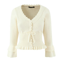 Cream-colored cardigan with ruffled details on a white background