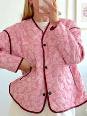 Quilted jacket with pink paisley print, showing front buttons