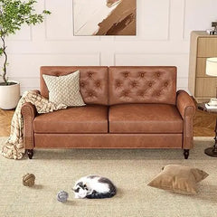 Brown leather sofa in a living room with a cat and toys on the floor.