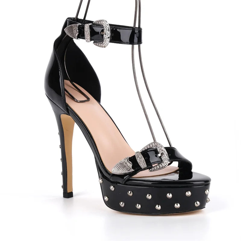 Black high-heeled shoe with studded details on a white background