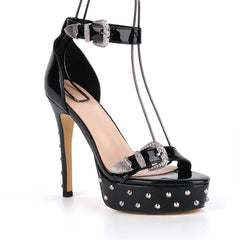 Black high-heeled shoe with studded details on a white background