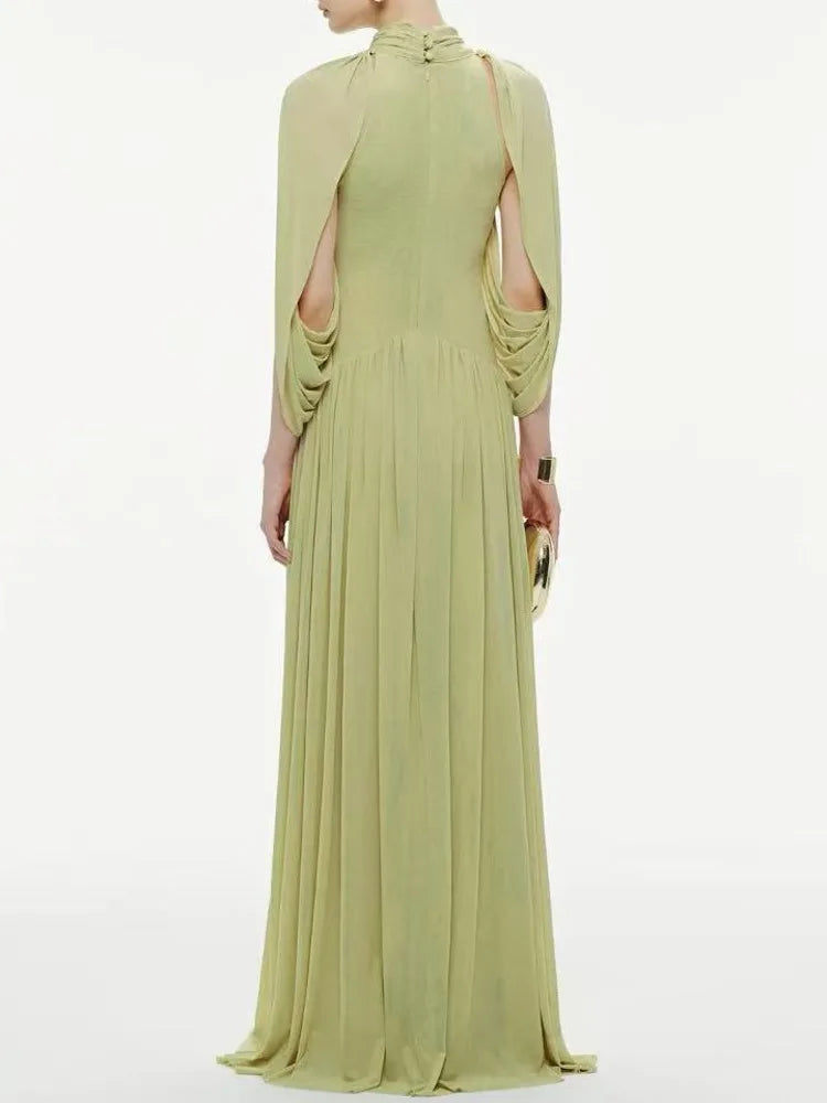 Light green evening gown with a draped design on a white background