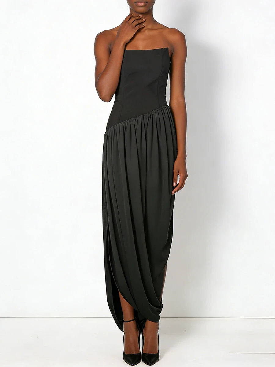 Black strapless dress worn by a model on a white background