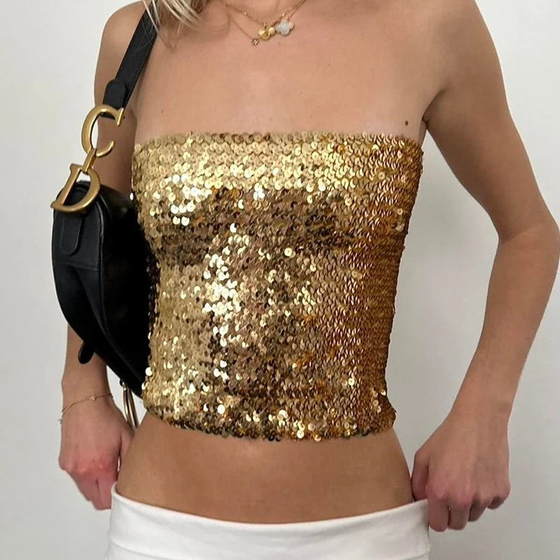 Gold sequin top worn by a person on a plain background