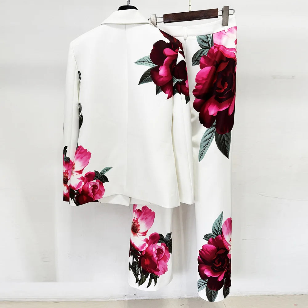 Floral print blazer and flare pants suit on hangers, back view.