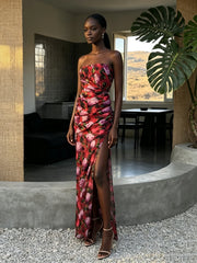Side profile of a woman wearing a floral print ruched maxi dress