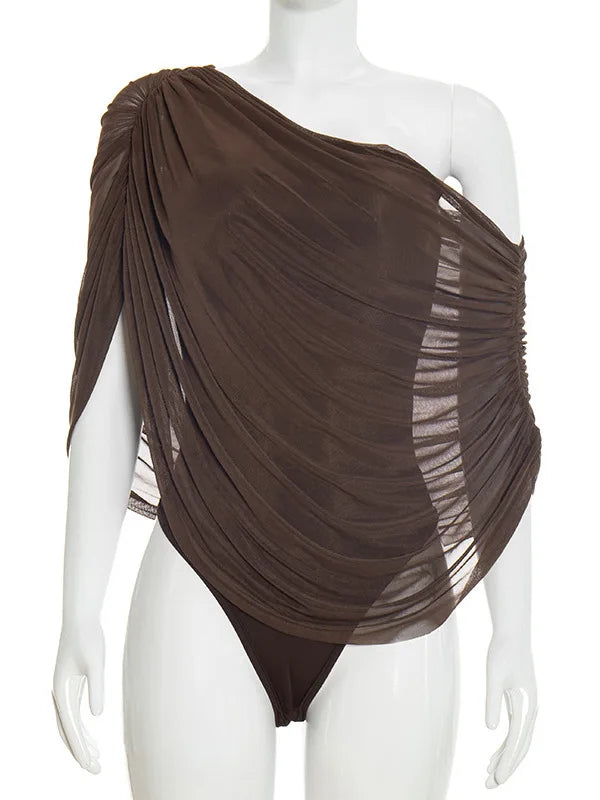 Brown draped garment on a mannequin against a white background