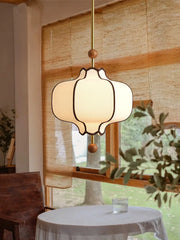Pendant light fixture in a room with a window and table