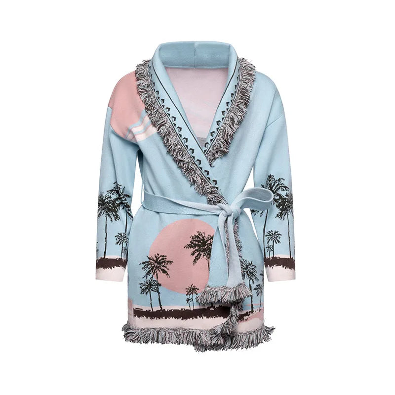Light blue robe with palm tree and sunset design on a white background
