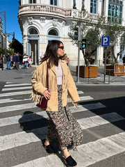 A model wearing a brown tassel jacket with a lapel design, showcasing its stylish details. Golden Atelier 4