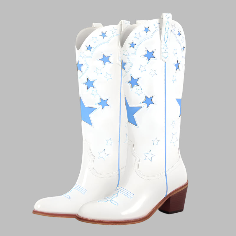 White cowboy boots with blue star patterns on a white background