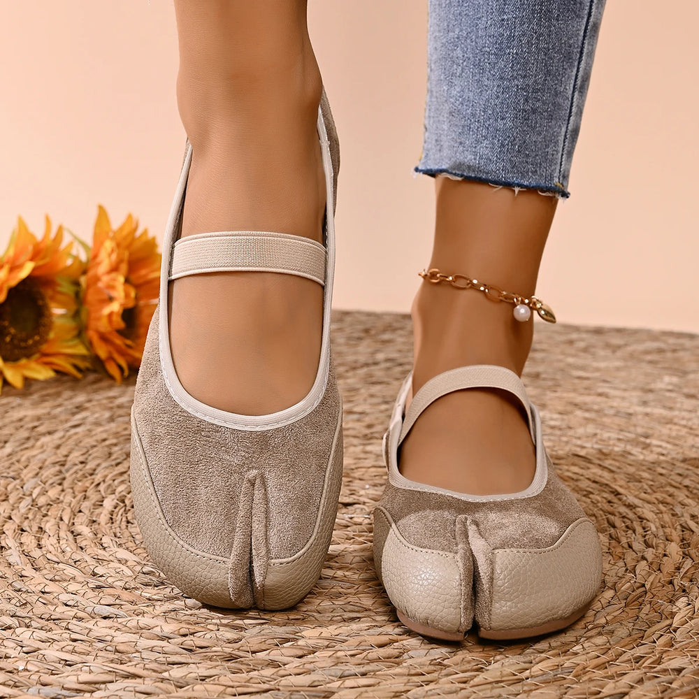 Beige split toe ballet flats on foot