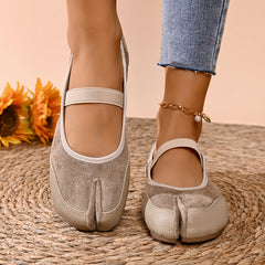 Beige split toe ballet flats on foot