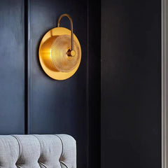 A dimly lit room with of gold wall sconces casting a romantic light  H