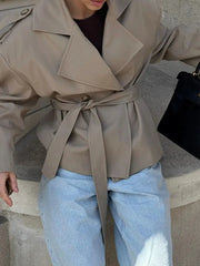 Close-up of belted double-breasted jacket detail