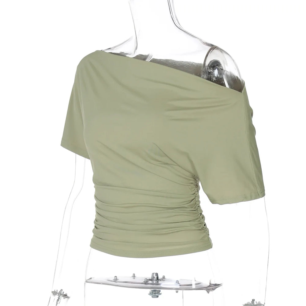 Green off-shoulder top on a mannequin with a white background
