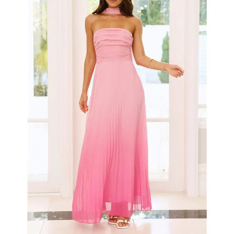 Woman wearing a strapless pink gown in a bright room with large windows.