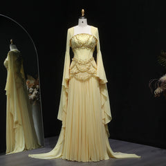 Elegant beige evening gown on a mannequin against a dark background
