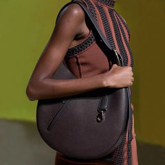 A woman stylishly carrying the crossbody bag, showcasing its versatility and size.