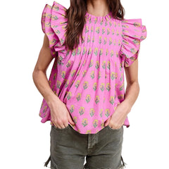 Person wearing a pink floral blouse with ruffled sleeves on a white background