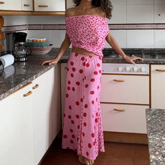 Person wearing a pink polka dot dress in a kitchen