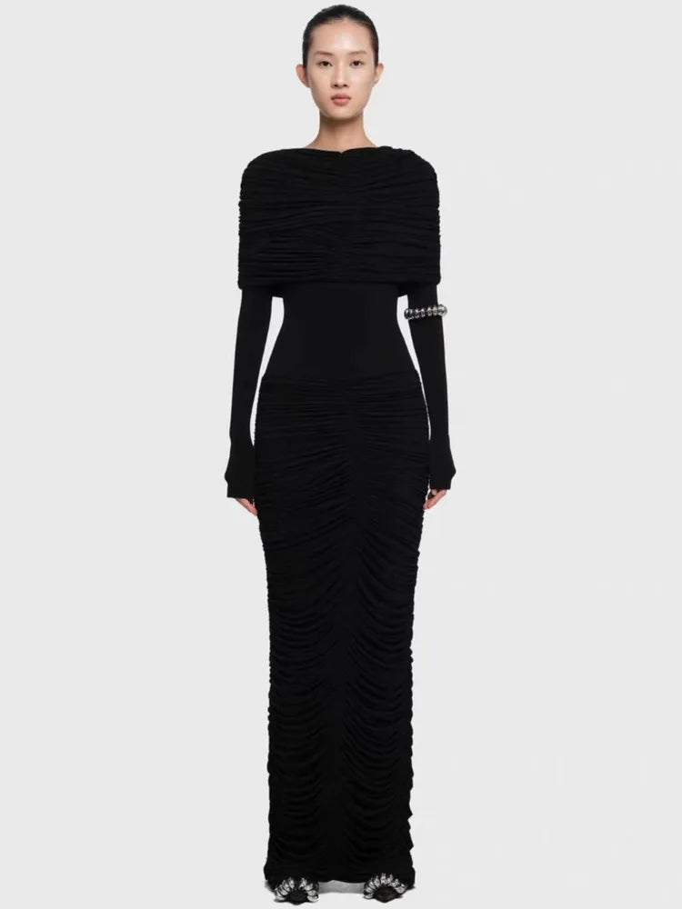Black evening gown with ruched design and silver embellishments on a white background