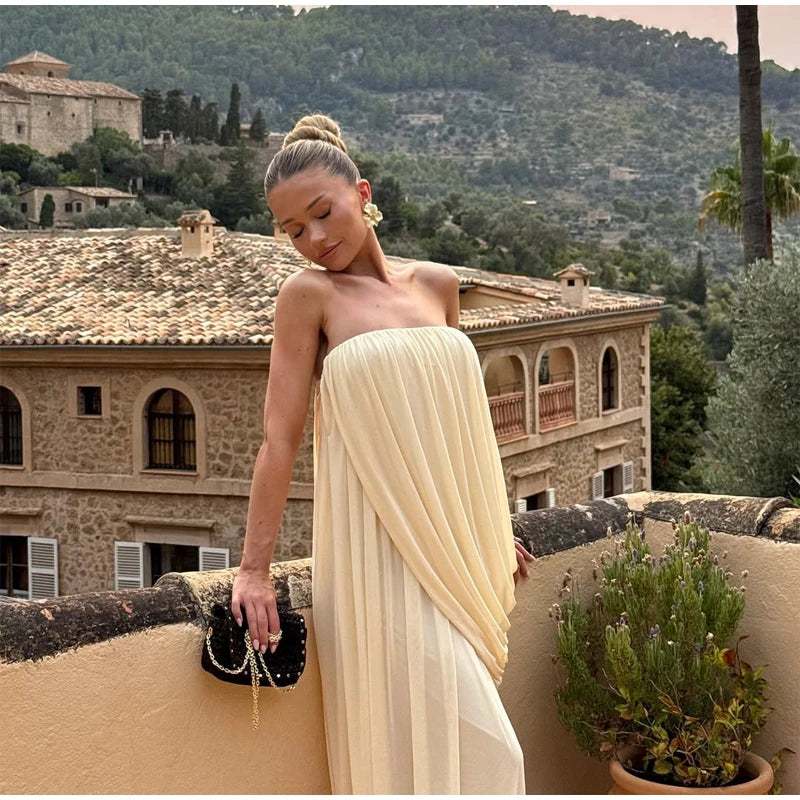 Strapless draped maxi dress on a balcony with a view