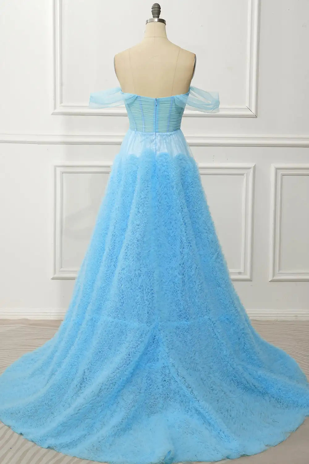 Light blue off-shoulder evening gown on a mannequin against a white wall.