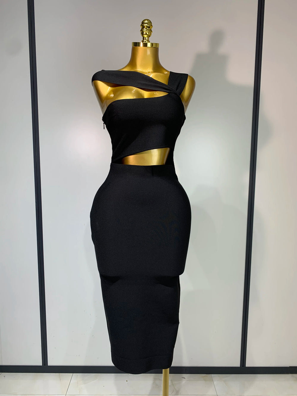 Black dress on a mannequin against a white background