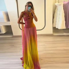 Woman wearing a colorful dress taking a mirror selfie in a store.