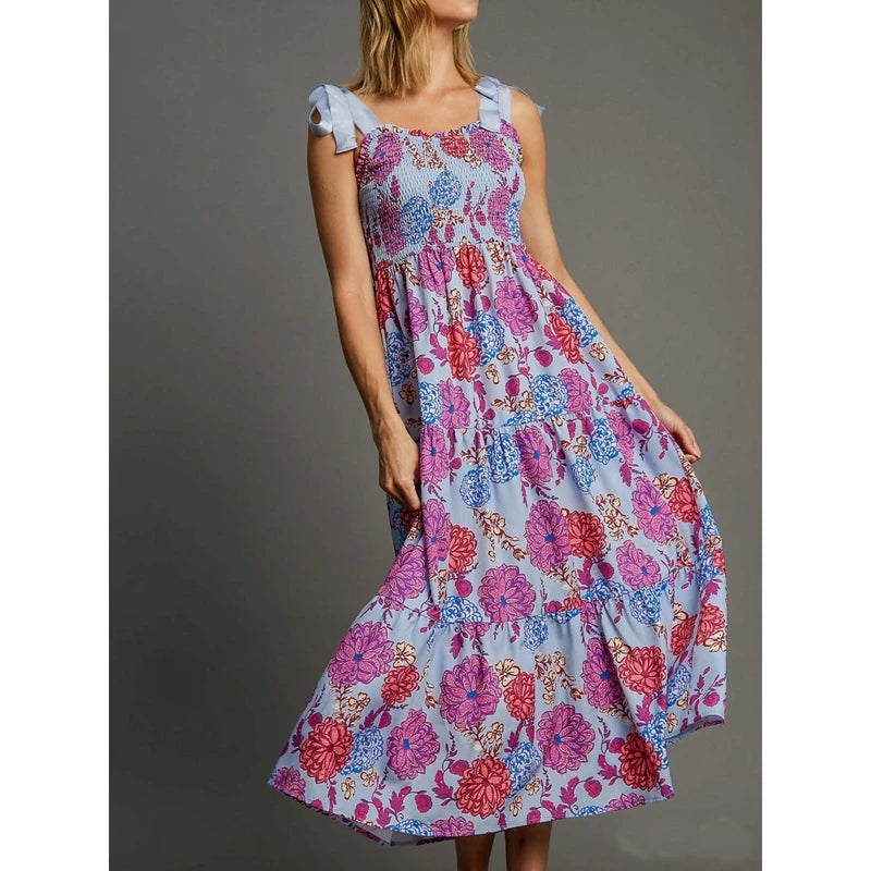 Light blue floral print smocked square neck maxi dress with light blue tie shoulder straps.
