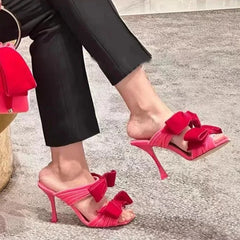 Pink velvet double bow stiletto mules on foot