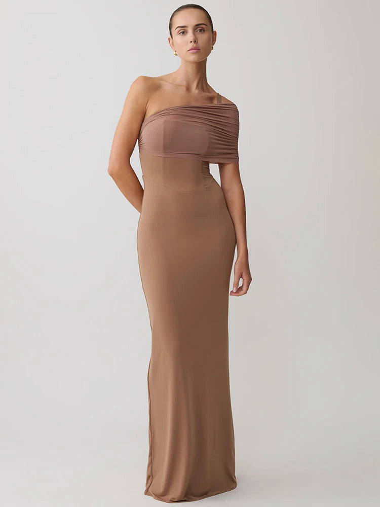 Woman wearing a brown strapless gown on a white background