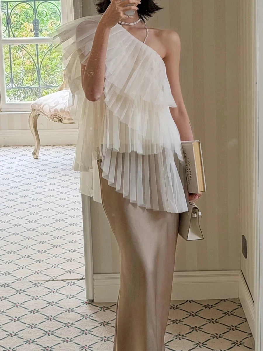 Model wearing a beige one shoulder mesh top
