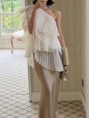 Model wearing a beige one shoulder mesh top