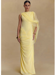 Woman wearing a yellow evening gown with a plain background