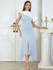 Woman wearing a light blue and white dress in an elegant interior setting.