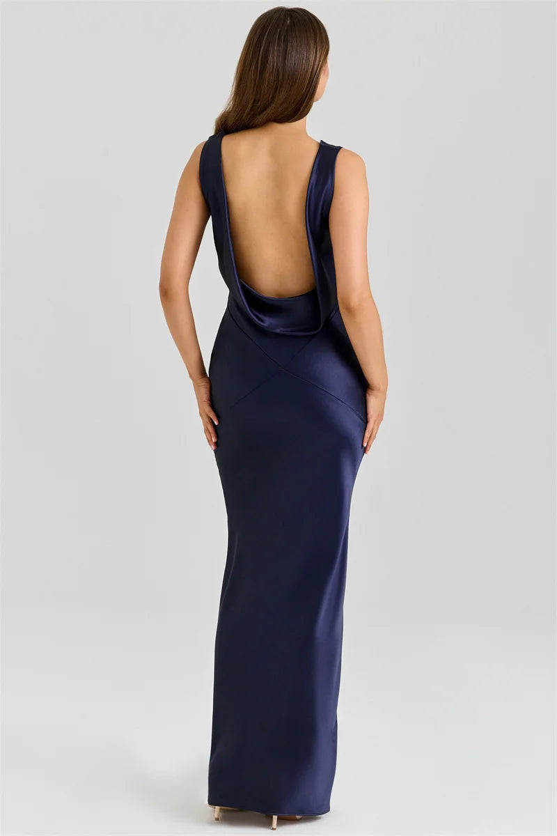 Navy blue evening gown with open back on a white background