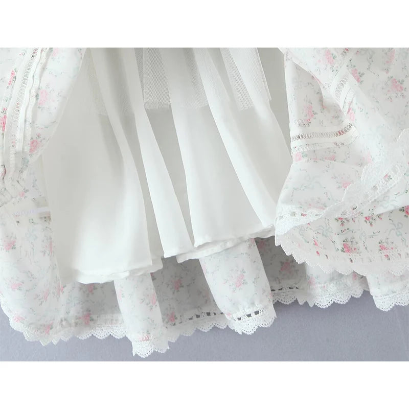 Close-up of a white lace skirt with floral patterns on a light gray background