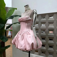 Side view of pink sparkle strapless mini dress