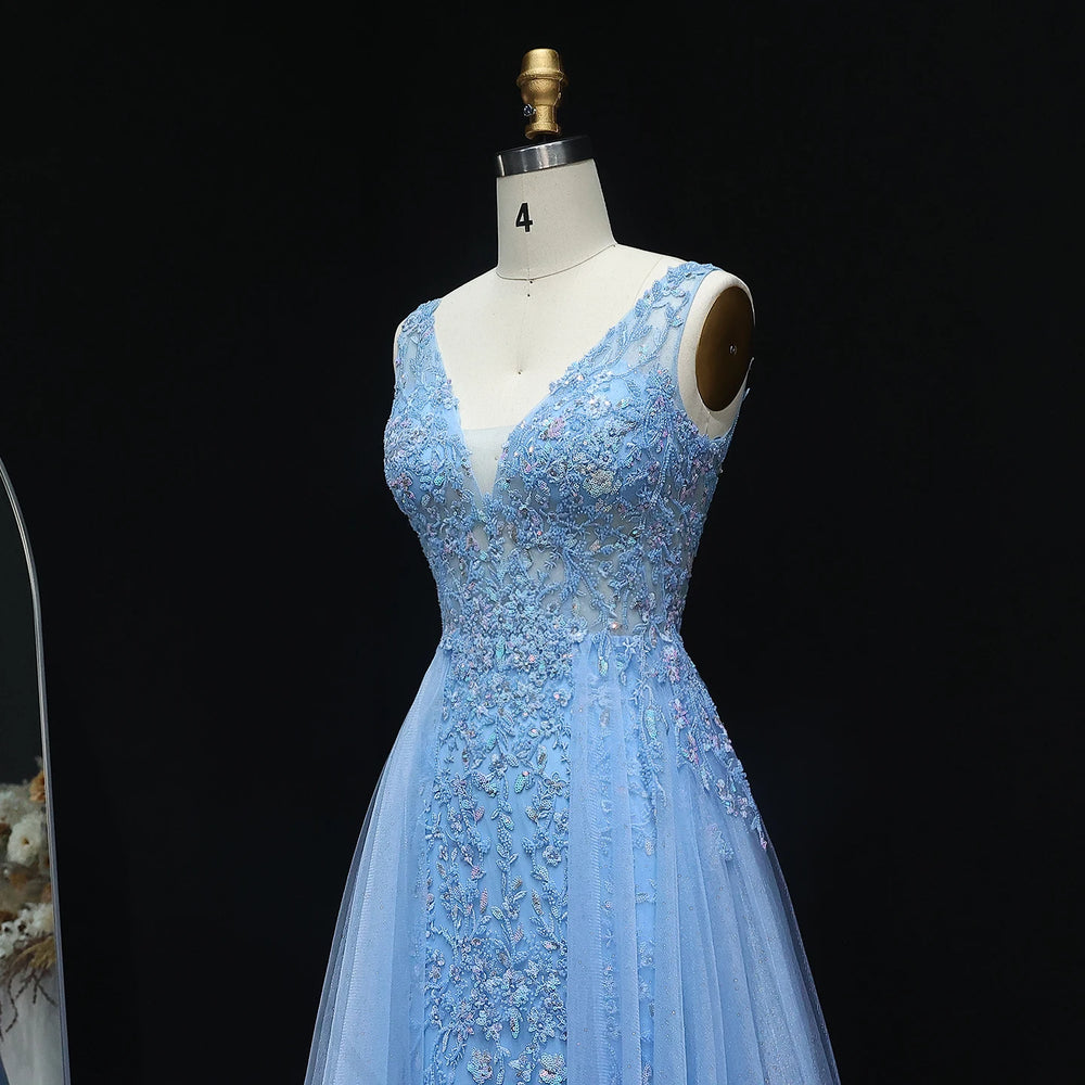 Light blue evening gown on a mannequin against a black background
