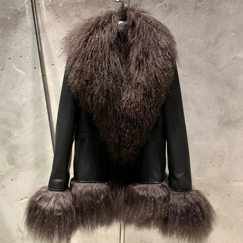 Black leather jacket with brown fur trim on a gray background