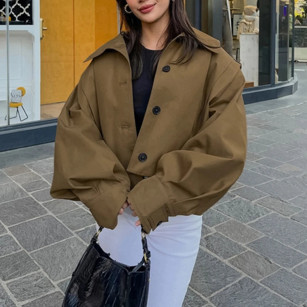 Person wearing a brown coat on a city street