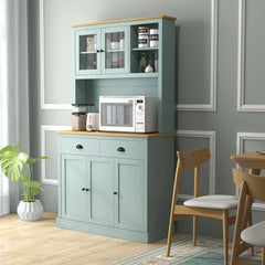 Kitchen cabinet with microwave and appliances against a gray wall.